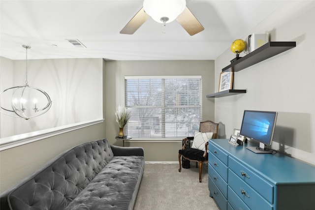 living area with ceiling fan with notable chandelier and light carpet