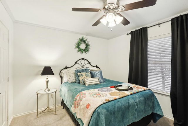 bedroom featuring ceiling fan and light carpet