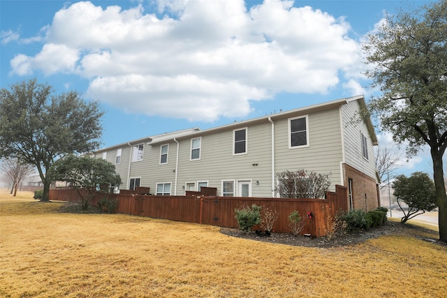 rear view of property with a lawn