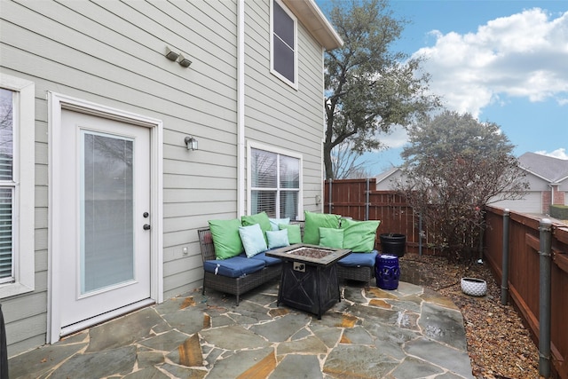 view of patio with an outdoor living space with a fire pit