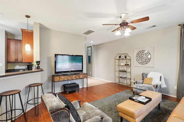 living room with ceiling fan and hardwood / wood-style floors