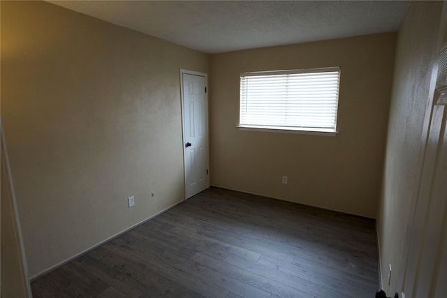 spare room with hardwood / wood-style flooring and a textured ceiling