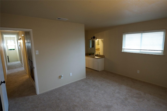 unfurnished bedroom with light colored carpet