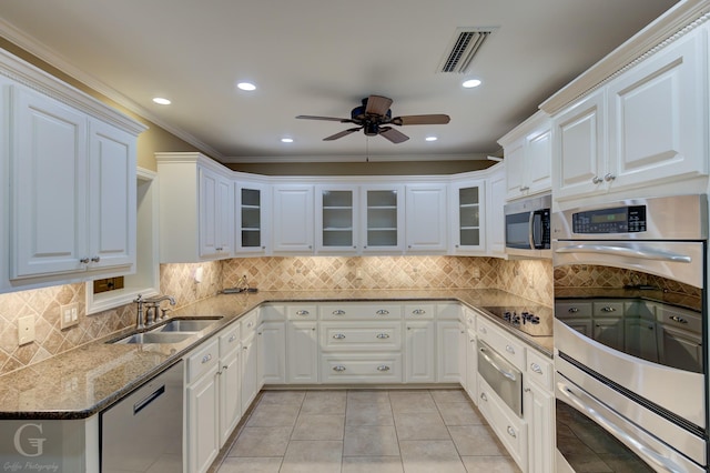 kitchen with stone countertops, appliances with stainless steel finishes, sink, and white cabinets