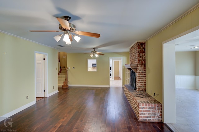 unfurnished living room featuring ornamental molding, dark hardwood / wood-style floors, and a fireplace