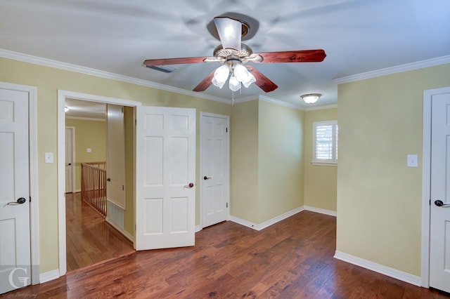 unfurnished bedroom with ornamental molding, dark hardwood / wood-style floors, and ceiling fan