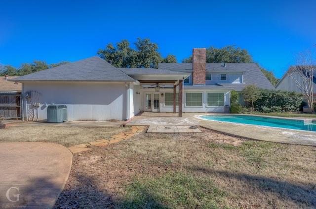 rear view of house with a patio, central AC unit, ceiling fan, and a lawn