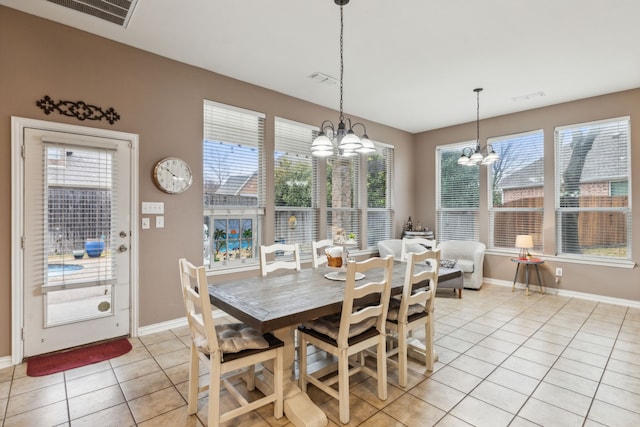 tiled dining area with a notable chandelier