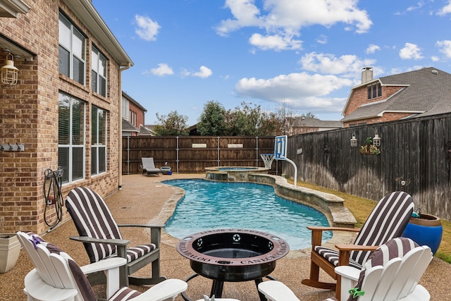 view of swimming pool featuring a patio, pool water feature, and an in ground hot tub