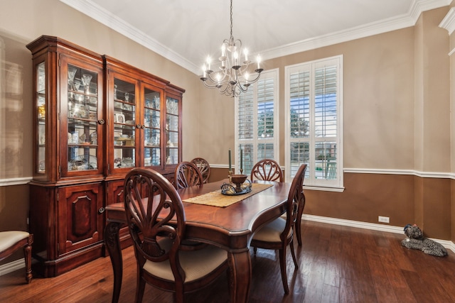 dining room featuring crown molding, dark hardwood / wood-style floors, and a chandelier