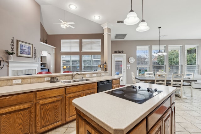 kitchen featuring a kitchen island, ceiling fan with notable chandelier, sink, light tile patterned floors, and black appliances