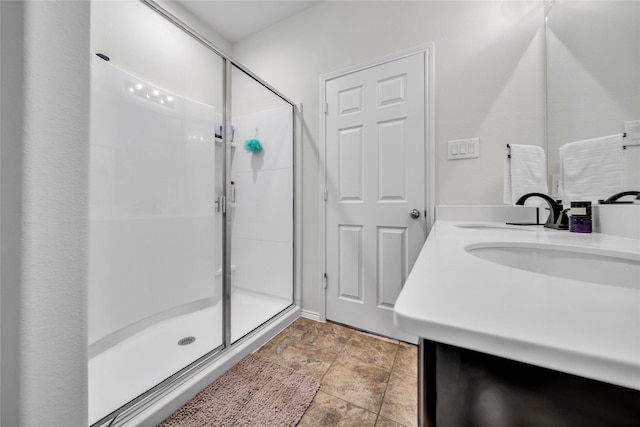 bathroom with walk in shower and vanity