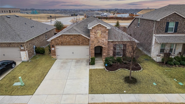 view of front of house with a garage and a lawn