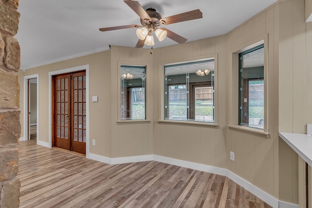 unfurnished room with french doors, ceiling fan, ornamental molding, and light hardwood / wood-style floors