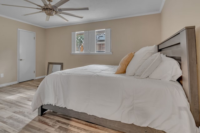 bedroom with crown molding, ceiling fan, and light hardwood / wood-style flooring