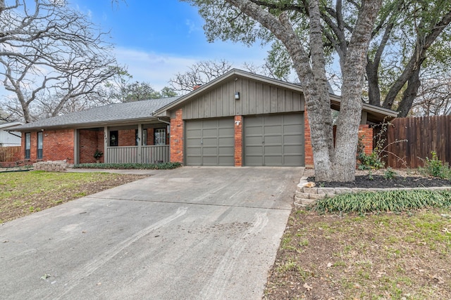 single story home featuring a garage and a porch