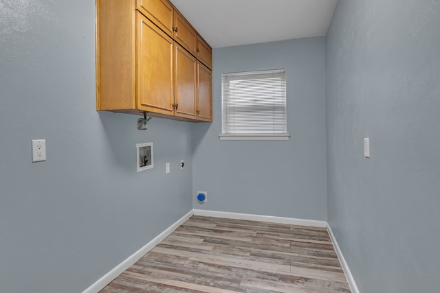 laundry area featuring cabinets, washer hookup, hookup for an electric dryer, and light hardwood / wood-style floors