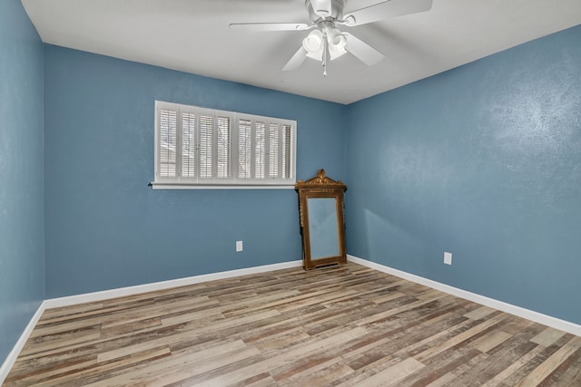 empty room featuring ceiling fan and light hardwood / wood-style flooring