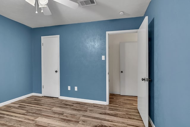 unfurnished bedroom with wood-type flooring and ceiling fan