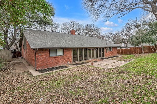 rear view of house with a yard and a patio