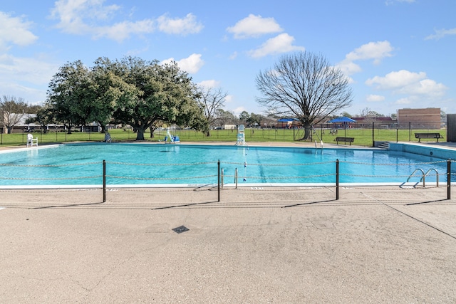 view of pool featuring a yard