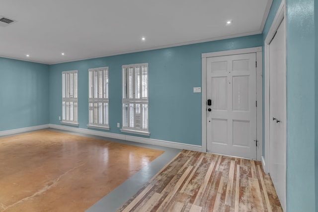 foyer entrance with crown molding and light hardwood / wood-style floors