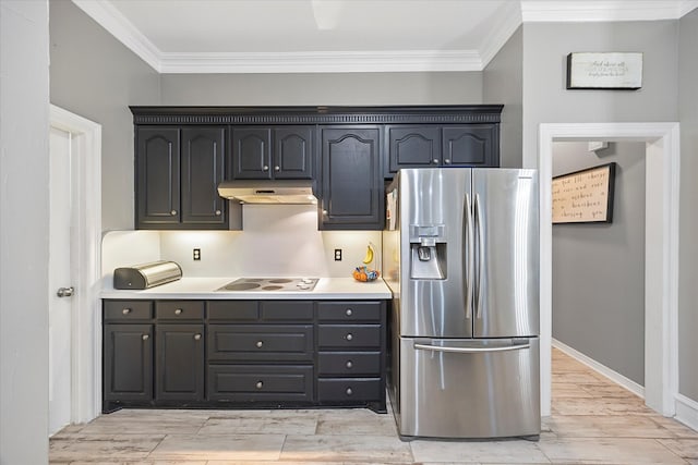 kitchen featuring ornamental molding, stainless steel fridge, and electric stovetop