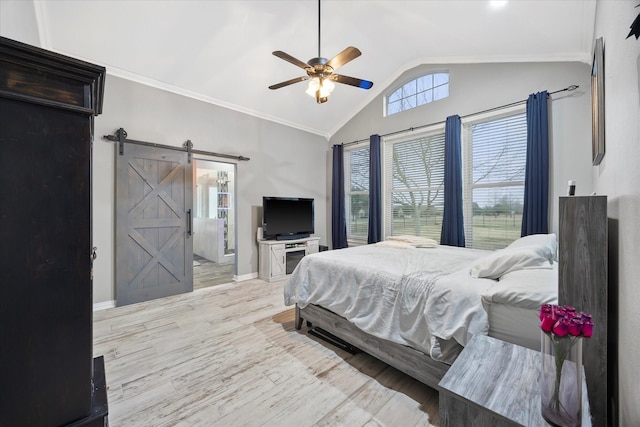 bedroom featuring vaulted ceiling, ornamental molding, ceiling fan, a barn door, and light hardwood / wood-style flooring