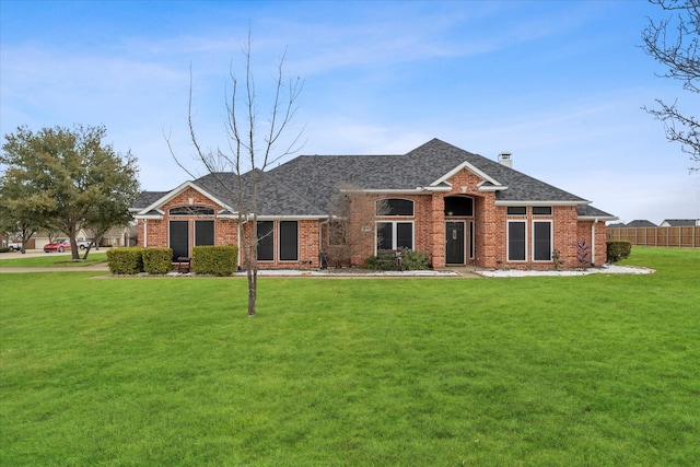 ranch-style house featuring a front lawn