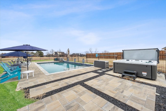 view of swimming pool with a hot tub and a patio area