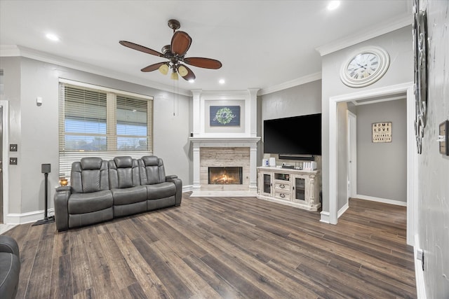 living room with dark hardwood / wood-style flooring, a fireplace, and ornamental molding