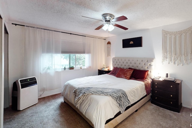 bedroom featuring heating unit, ceiling fan, a textured ceiling, and carpet flooring