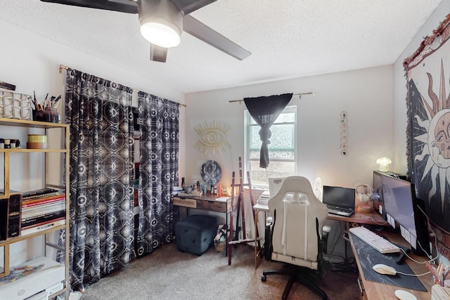 office area with ceiling fan, carpet floors, and a textured ceiling