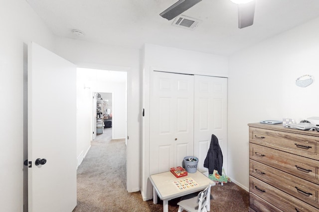 interior space featuring light carpet, a closet, and ceiling fan