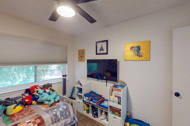 bedroom featuring ceiling fan and carpet