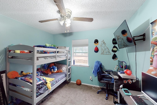 carpeted bedroom featuring ceiling fan and a textured ceiling