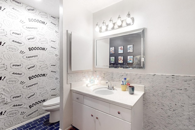 bathroom featuring vanity, tile patterned floors, tile walls, and toilet