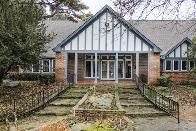 rear view of property featuring a sunroom