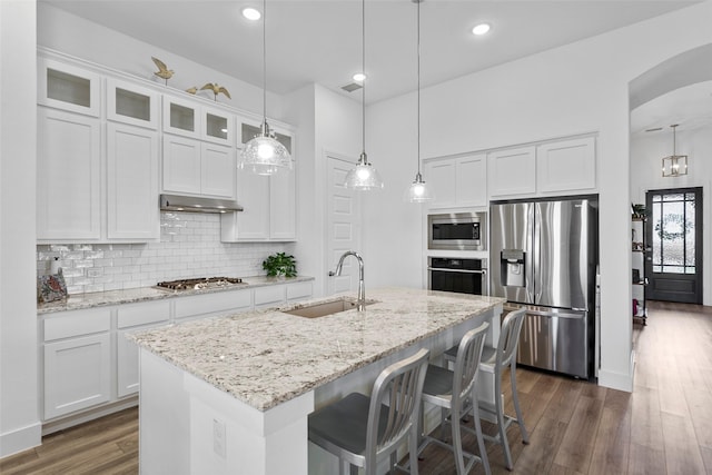 kitchen with appliances with stainless steel finishes, sink, and white cabinets