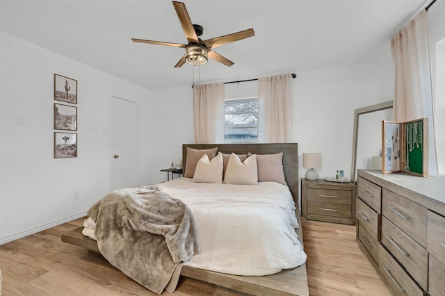 bedroom with ceiling fan and light hardwood / wood-style flooring