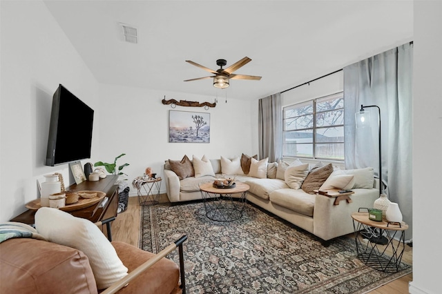 living room with hardwood / wood-style floors and ceiling fan