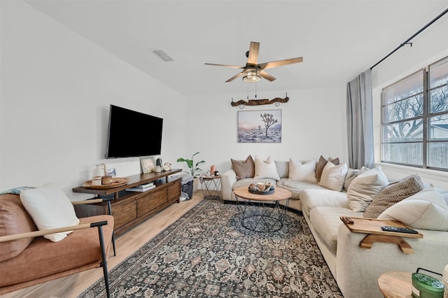 living room with hardwood / wood-style flooring and ceiling fan