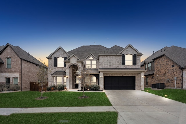 french country style house with a garage and a yard