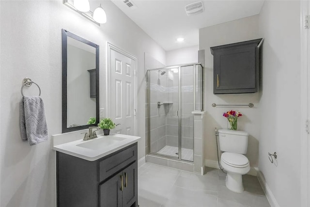 bathroom featuring vanity, tile patterned flooring, toilet, and walk in shower