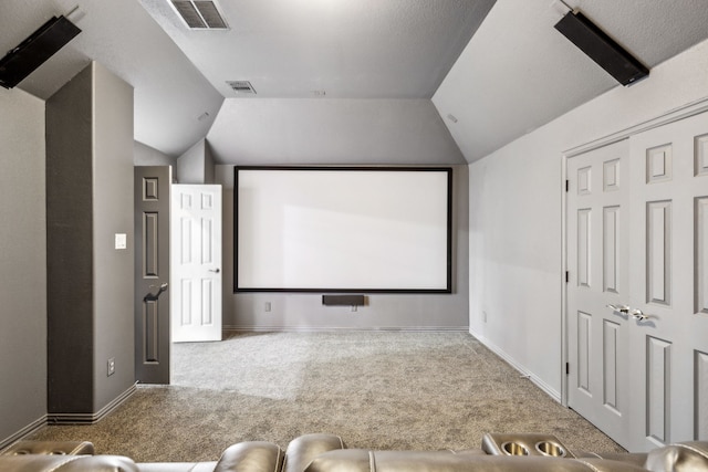 carpeted home theater room featuring lofted ceiling