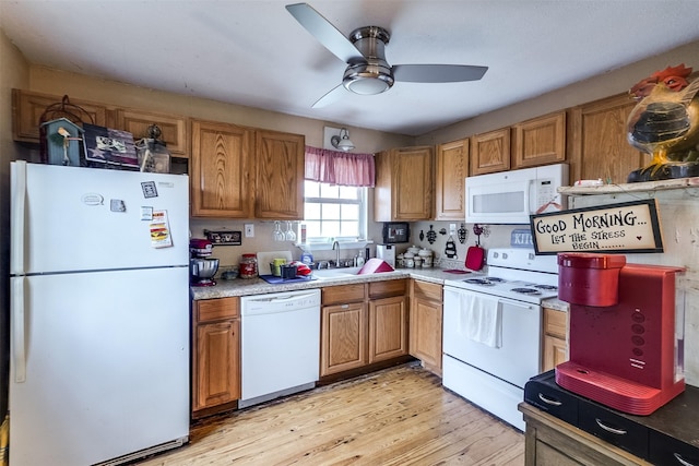 kitchen with ceiling fan, sink, white appliances, and light hardwood / wood-style floors