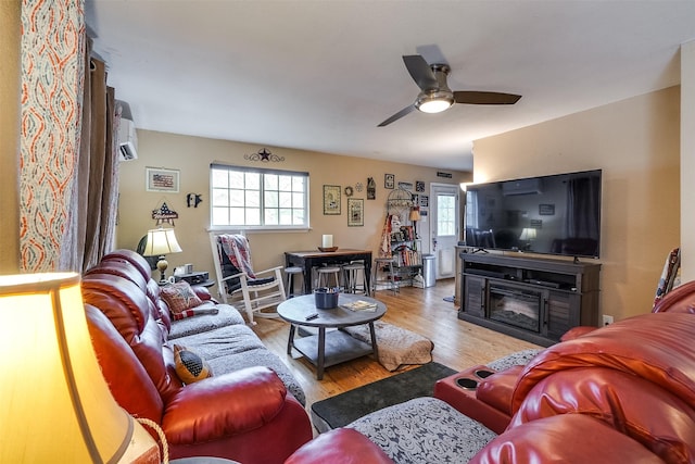 living room with ceiling fan, a healthy amount of sunlight, and light hardwood / wood-style floors