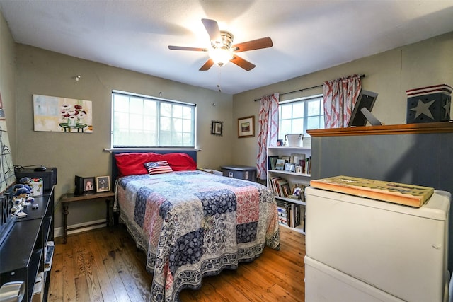 bedroom with hardwood / wood-style floors and ceiling fan