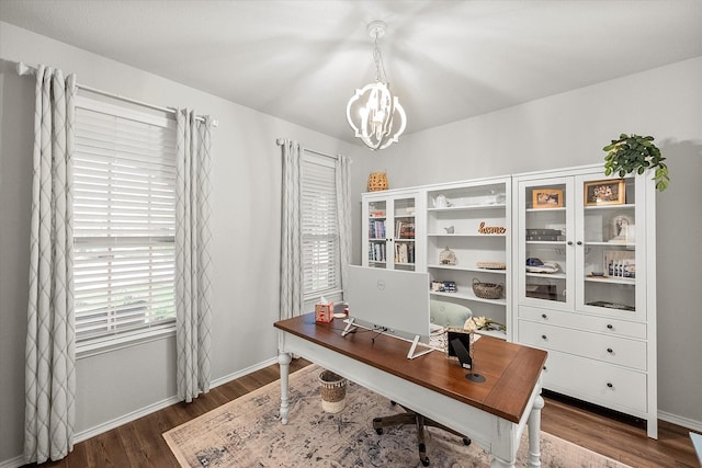 office space with dark hardwood / wood-style flooring and a notable chandelier