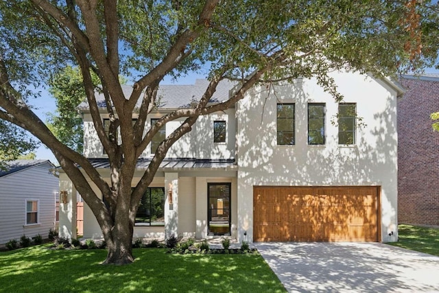 view of front of home featuring a garage and a front lawn